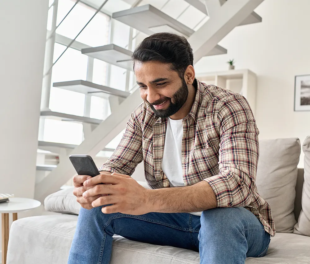 man smiling at phone